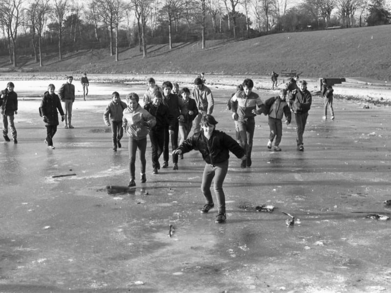Children sliding on a frozen Inverleith pond, iced over during the cold weather in February 1985.