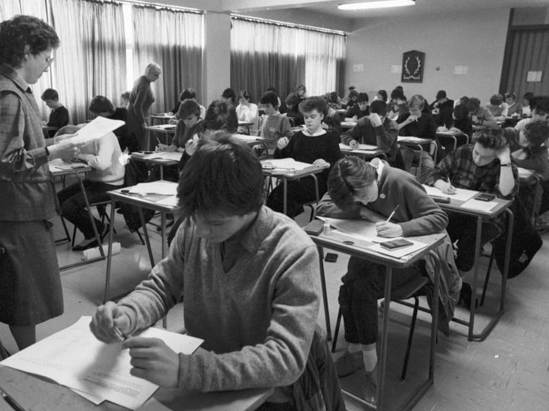 Pupils from Edinburgh's Broughton High School in the classroom sitting their 'O' grade exams in April 1985. A teacher on invigilation durites stands at the front of the room.