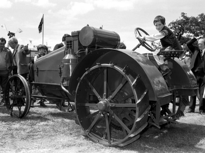 Young Robbie Simmons at the controls of a vintage tractor on display at the Royal Highland Show at Ingliston, June 1985.