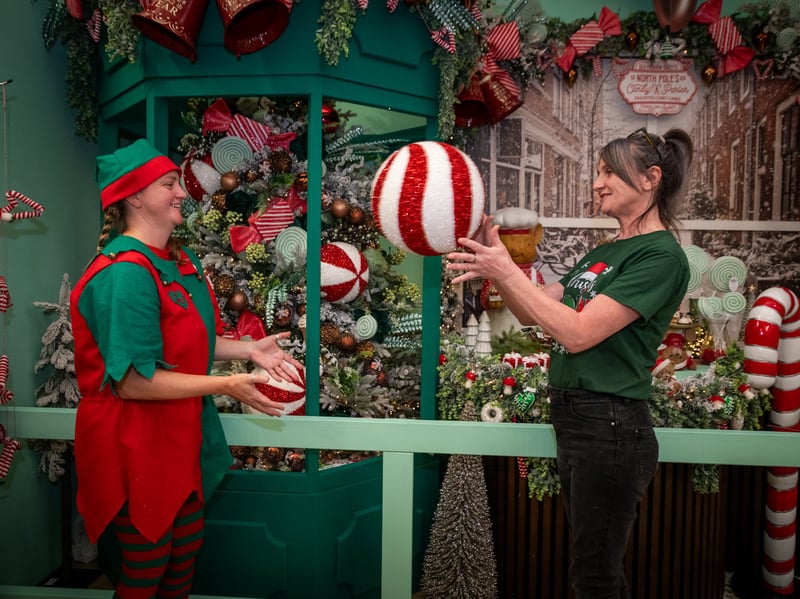 Donna Zaremba and Andrea Allan have fun in front of one of the Christmas displays. 