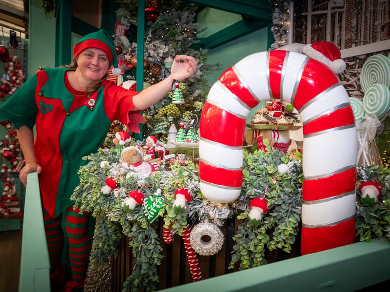 Donna Zaremba placing decorations on one of the displays.
