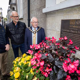 Mayor of Mid and East Antrim, Alderman Thomas Gordon, welcomes delegates from World Heritage UK to the UNESCO site at Gracehill.