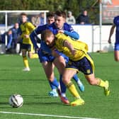 Limavady United and Ballymena United compete for possession. 