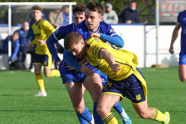 Limavady United and Ballymena United compete for possession.