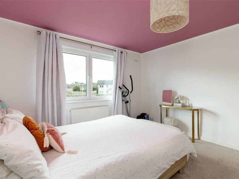 The Davidson's Mains property's spacious principal bedroom with fitted wardrobes and fitted carpet.