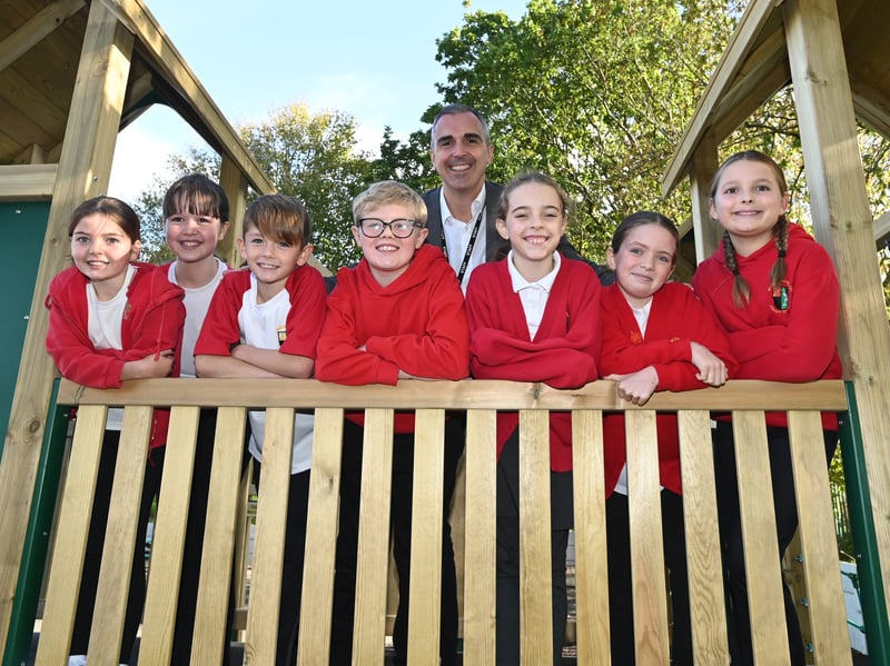 Headteacher Mr Hewitt with members of the school council are delighted with their new play equipment.