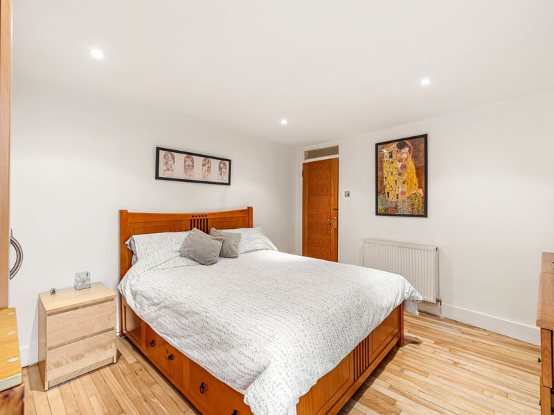 The principal bedroom benefits from its own en-suite shower room, while a versatile family room with an exposed stone fireplace offers flexibility as a second sitting room or home office. 