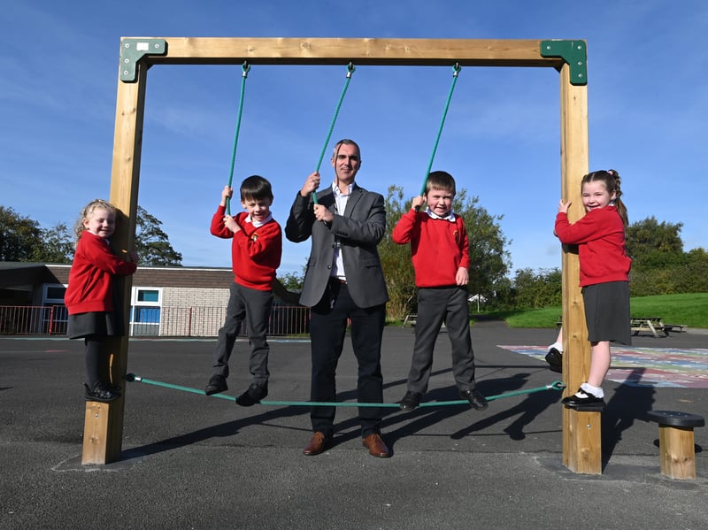 Headteacher Mr Hewitt with Key Stage One pupils enjoying their new play equipment. 
