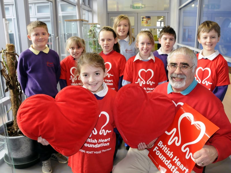 Pupils took part in a Rock Up In Red Day in 2013 and raised money for the British Heart Foundation, represented by Michael Roper, right.