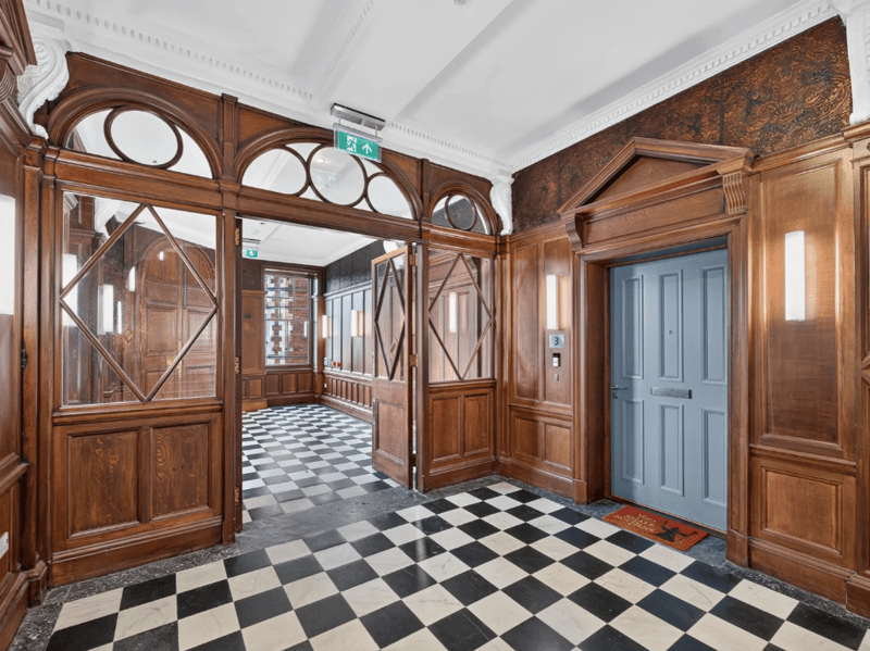 Accessed via a secure entry system, the bright and immaculately presented accommodation includes this welcoming entrance hallway with a utility cupboard.