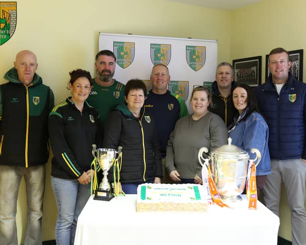 SOME members of Dorsey Emmet’s GFC committee l-r Aidan Lennon, Fiona McCreesh, Ciaran Lennon, Maureen Moley, Pearse McGee, Mary McGlinchey, Ciaran McGlinchey, Natalie Campbell and Conor Campbell Chairperson with the Armagh Cup and a delicious cake to mark the opening of the 4G Pitch. LB4065