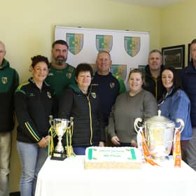 SOME members of Dorsey Emmet’s GFC committee l-r Aidan Lennon, Fiona McCreesh, Ciaran Lennon, Maureen Moley, Pearse McGee, Mary McGlinchey, Ciaran McGlinchey, Natalie Campbell and Conor Campbell Chairperson with the Armagh Cup and a delicious cake to mark the opening of the 4G Pitch. LB4065