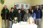 SOME members of Dorsey Emmet’s GFC committee l-r Aidan Lennon, Fiona McCreesh, Ciaran Lennon, Maureen Moley, Pearse McGee, Mary McGlinchey, Ciaran McGlinchey, Natalie Campbell and Conor Campbell Chairperson with the Armagh Cup and a delicious cake to mark the opening of the 4G Pitch. LB4065