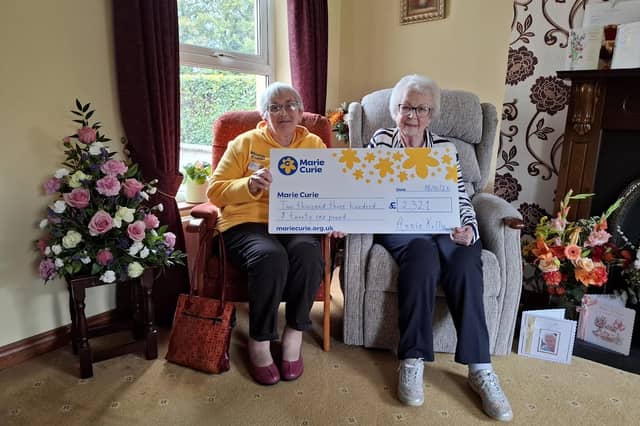 Annie Kelly of Killyclogher, right, presents Moira McCallion from Marie Curie the donations she received in lieu of presents for her 100th birthday. SU6142CD26