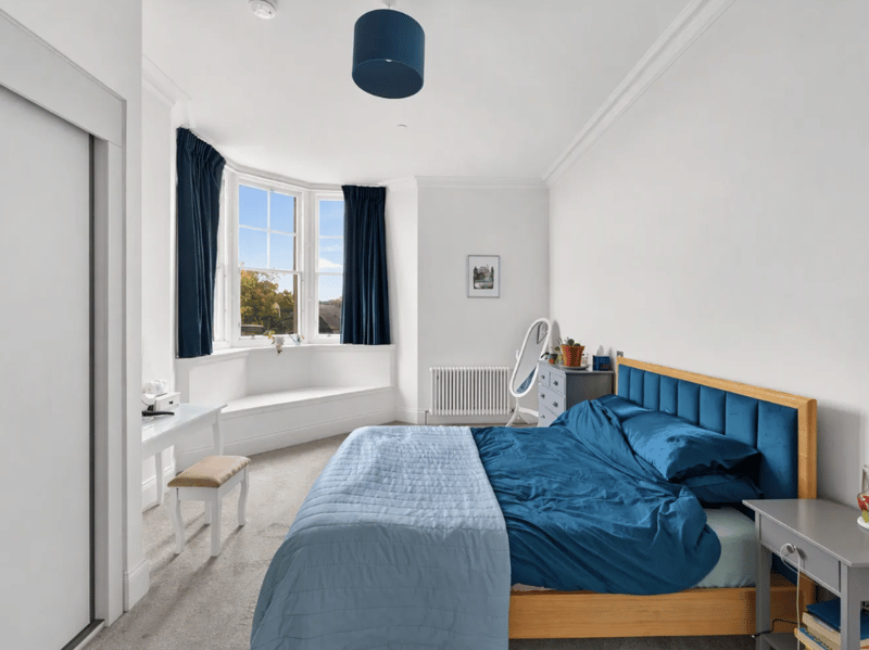 There are two generous double bedrooms, including this stunning principal bedroom featuring a striking corner bay window and built-in storage.