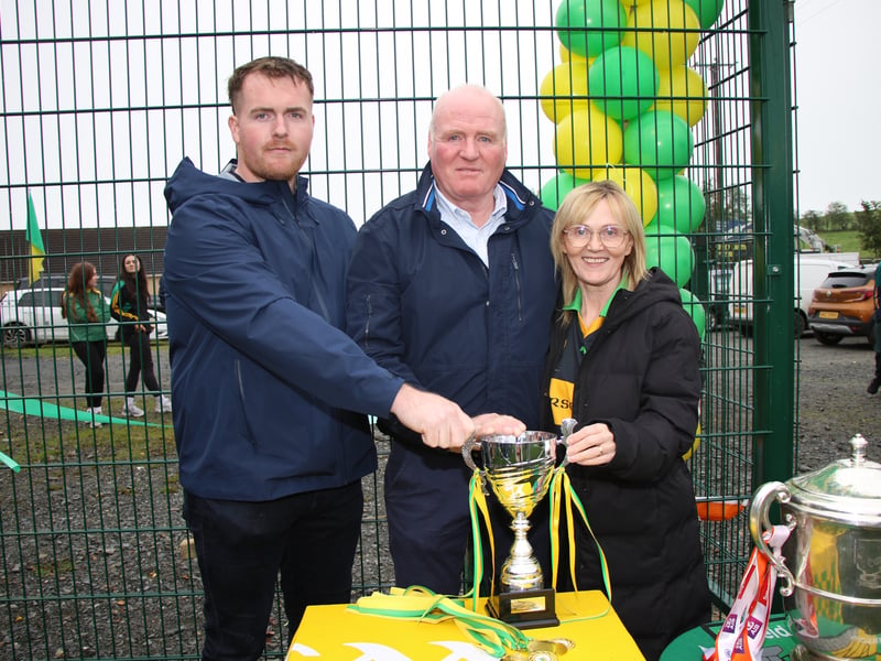 MICÉAL Murphy's brother Brian and his Dad Kevin and Mum Fidelma holding his Memorial Cup for the first game played on the new 4G pitch at Dorsey Emmet's GFC. LB4079