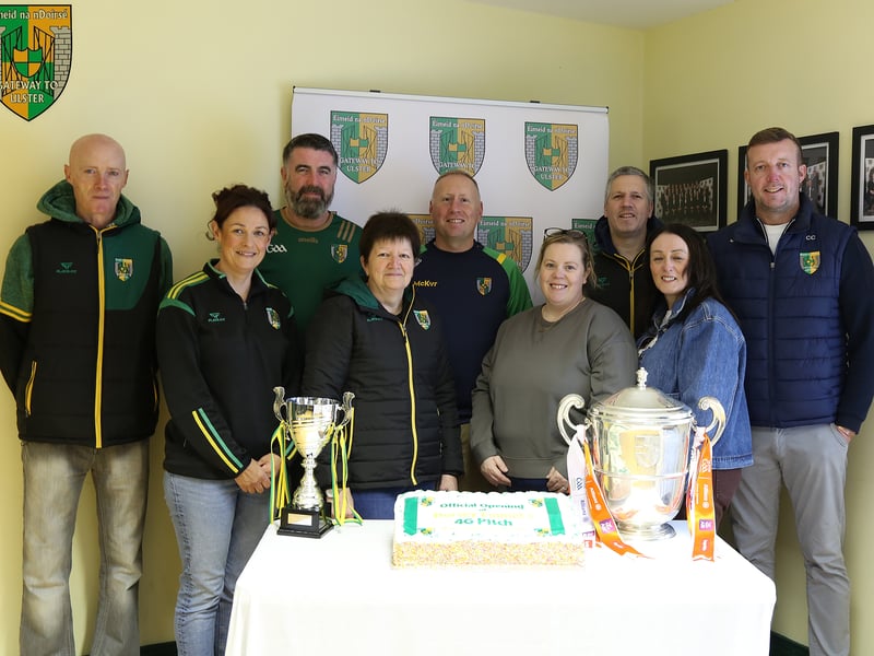 SOME members of Dorsey Emmet’s GFC committee l-r Aidan Lennon, Fiona McCreesh, Ciaran Lennon, Maureen Moley, Pearse McGee, Mary McGlinchey, Ciaran McGlinchey, Natalie Campbell and Conor Campbell Chairperson with the Armagh Cup and a delicious cake to mark the opening of the 4G Pitch. LB4065