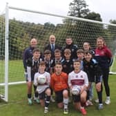 St Paul's High School Bessbrook staff, pupils and supporters in front of their new goals.