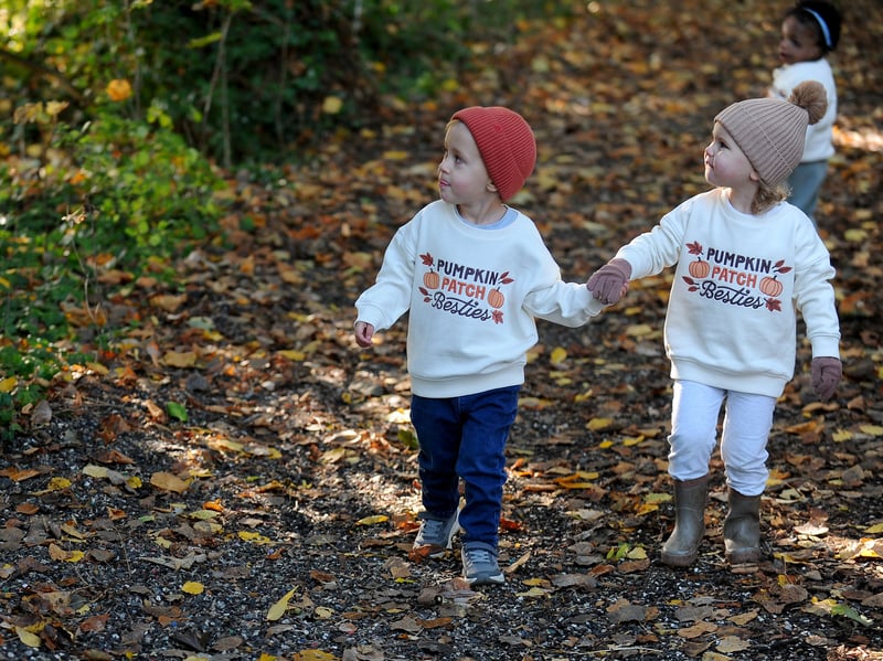 Lucas Mitton and Isla Essery holding hands in the scary woods