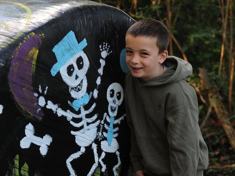 Jacob Gahan smiling with some painted skeletons 