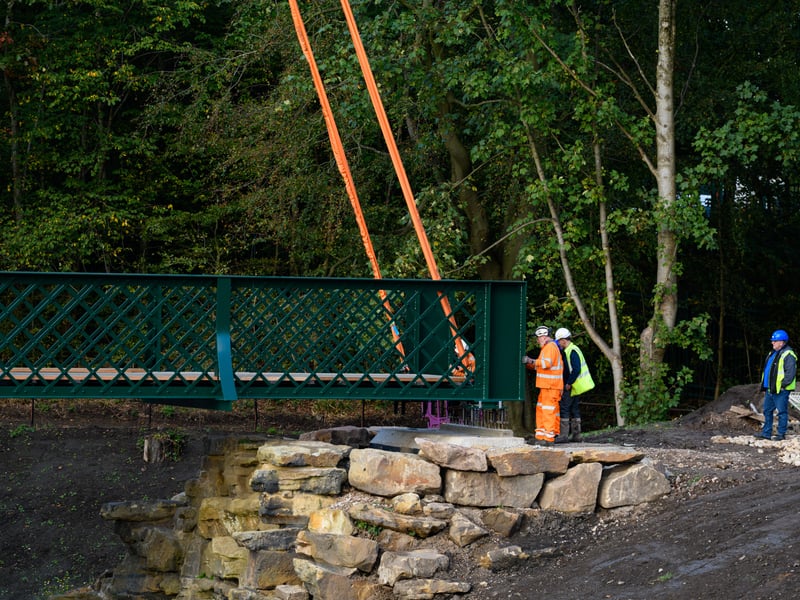 Serpentine Lake bridge is lowered into place by crane at Moor Park, Preston. Photo: Kelvin Lister-Stuttard