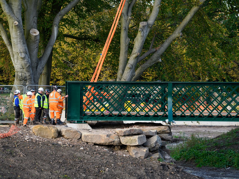 Serpentine Lake bridge is lowered into place by crane at Moor Park, Preston. Photo: Kelvin Lister-Stuttard