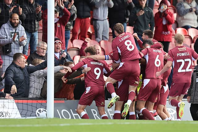 Jon Guthrie and his team-mates celebrates with the away fans at Blundell Park