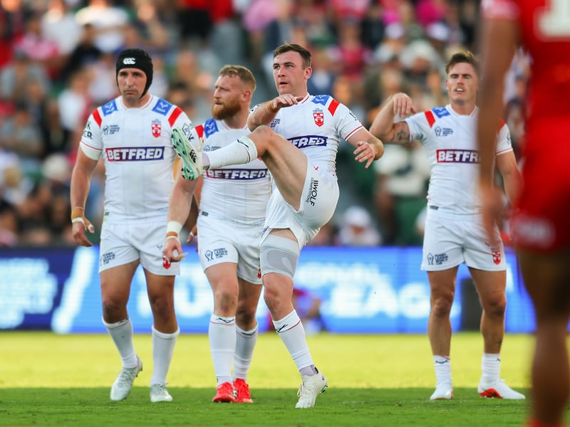 England halfback Harry Smith kicks downfield against Tonga