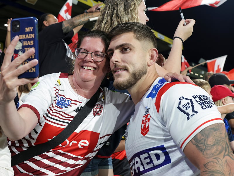 A Wigan fan takes a selfie with Brad O'Neill after the game