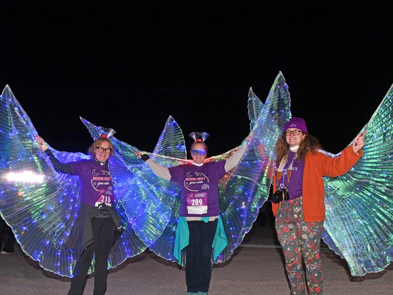 Walkers taking part in the event illuminate the night with their vibrant glowing accessories