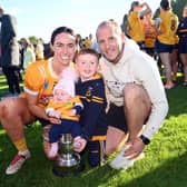 Wife and husband Paula and Darren O'Hagan with their two children and the Down Senior Camogie title.