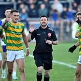 Referee Paul Gallagher is surrounded by Edendork  players in the closing minutes over a controversial call during the Tyrone Senior Football Championship  final at Omagh, Co. Tyrone.