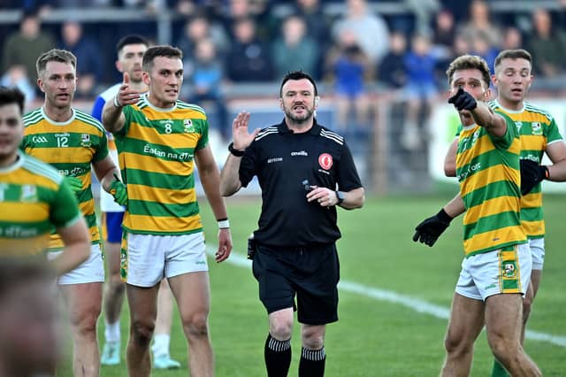 Referee Paul Gallagher is surrounded by Edendork players in the closing minutes over a controversial call during the Tyrone Senior Football Championship final at Omagh, Co. Tyrone.