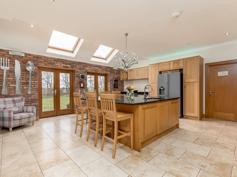 The substantial kitchen/breakfast room comes with a central island and French doors opening to the garden, creating an excellent space for everyday family life and entertaining. An adjoining utility room provides further practical accommodation.