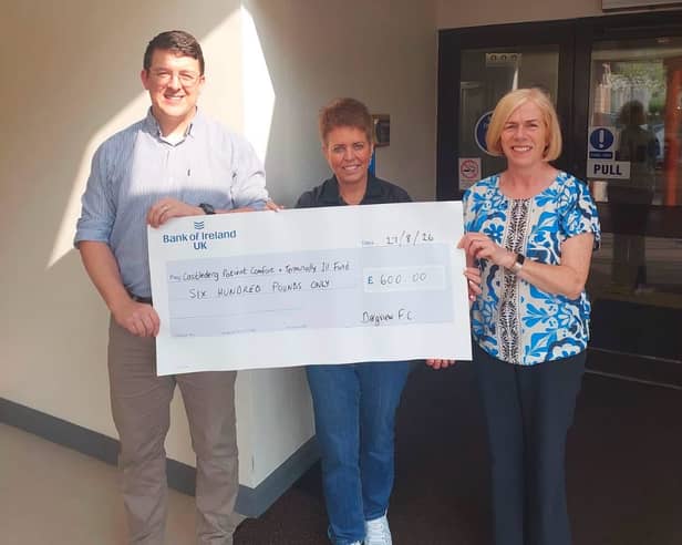 Sharon Scott, centre, Dergview FC treasurer, presents a cheque for £600 to Phillip Haire and Susan Young, committee members of the Castlederg Patient Comfort and Terminally Ill Fund. The funds were raised at the annual John Forsythe Memorial Cup at Darragh Park.