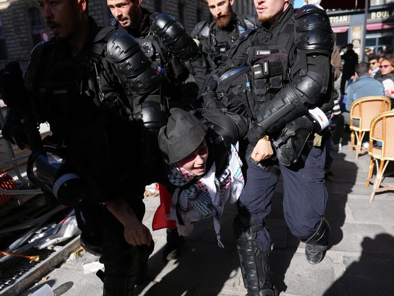 A protester is detained by police during a march from Place de la Republique, as the the Gilets Jaunes join students for a weekend of action on October 17