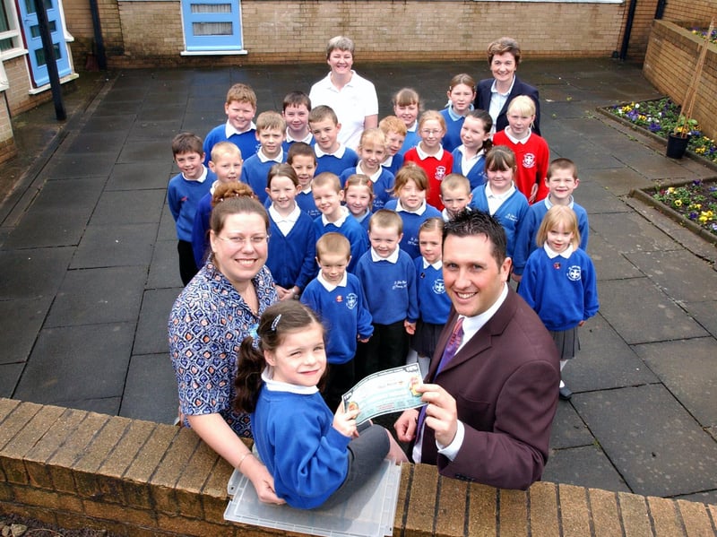 Discount holiday vouchers were being handed out when this photo was taken in 2004. Pupils were joined by Vanessa Reay of Hays Travel and Glen Riddle of Every School Day Counts.