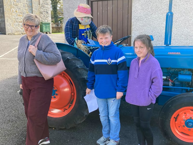 Enjoying their day seeing the vast array of scarecrows including Farmer Scarecrow. ST264313