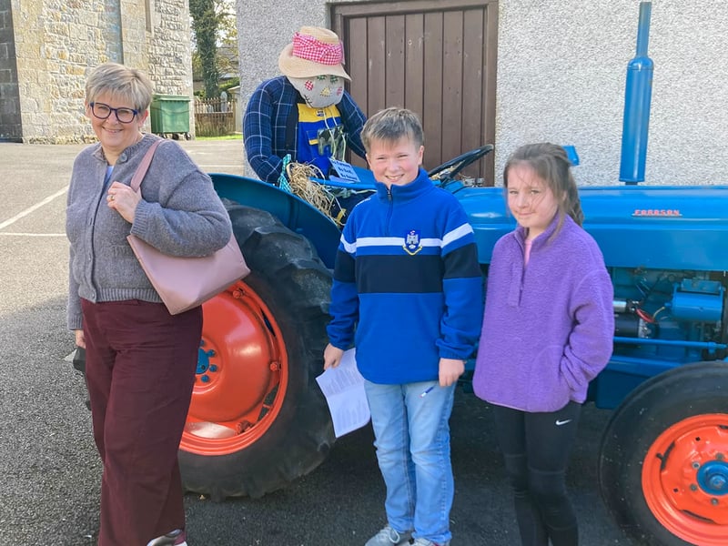 Enjoying their day seeing the vast array of scarecrows including Farmer Scarecrow. ST264313