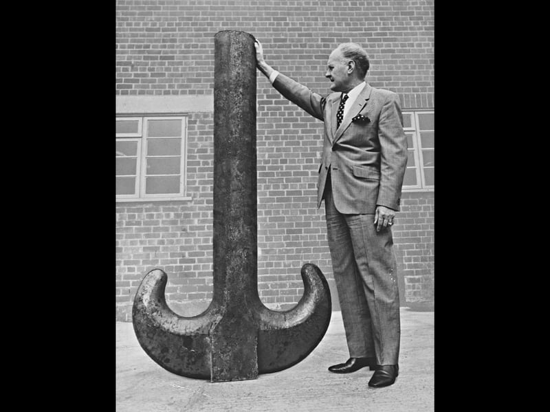 Standing beside a colossal ramshorn hook that towers almost to his shoulder, managing director S H Tompson demonstrates the sheer scale of heavy forgings produced at J Parkes and Co (Old Hill) Ltd on October 30, 1970. Weighing 14 cwts and standing 5ft 10ins high, the massive hook was engineered to carry a safe working load of 150 tons for a leading crane manufacturer in Cradley Heath. Manufactured as part of the Lunt, Comley and Pitt group, the impressive piece showcases the immense metalworking capability and heavy engineering pride rooted in the heart of Cradley Heath and Old Hill. Do you remember seeing massive industrial components like this being forged or transported through Cradley Heath and Old Hill? Did you or anyone in your family work in the local heavy forging or foundry trades back in the 1970s?