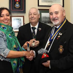 Anne McGarrigle presents her late father Ernie Cockburn’s medals to Royal British Legion Club chairman, Kenneth Alexander and RBL Branch chairman, Derek Shields.   IB0243CD26