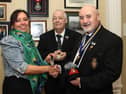 Anne McGarrigle presents her late father Ernie Cockburn’s medals to Royal British Legion Club chairman, Kenneth Alexander and RBL Branch chairman, Derek Shields.   IB0243CD26