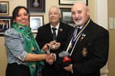 Anne McGarrigle presents her late father Ernie Cockburn’s medals to Royal British Legion Club chairman, Kenneth Alexander and RBL Branch chairman, Derek Shields.   IB0243CD26
