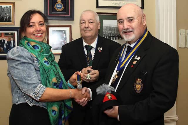 Anne McGarrigle presents her late father Ernie Cockburn’s medals to Royal British Legion Club chairman, Kenneth Alexander and RBL Branch chairman, Derek Shields. IB0243CD26