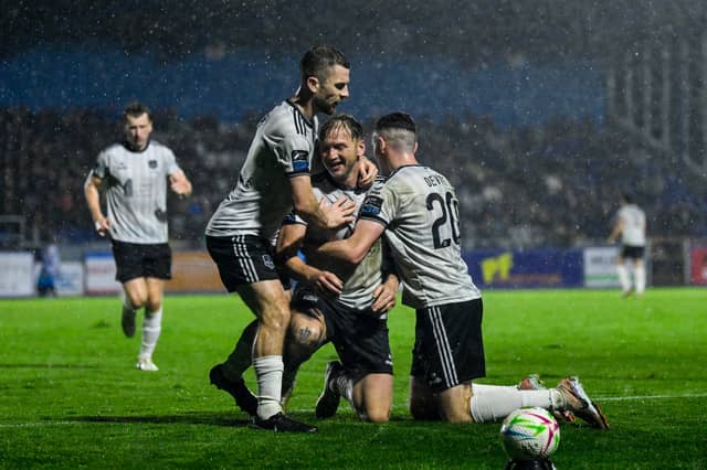 Stephen Walsh is congratulated by Aaron Bolger and Lee Devitt after scoring the equaliser in Waterford on Monday night.
