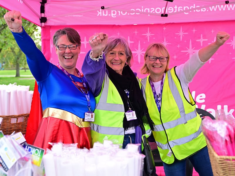 Volunteers strike a superhero pose.