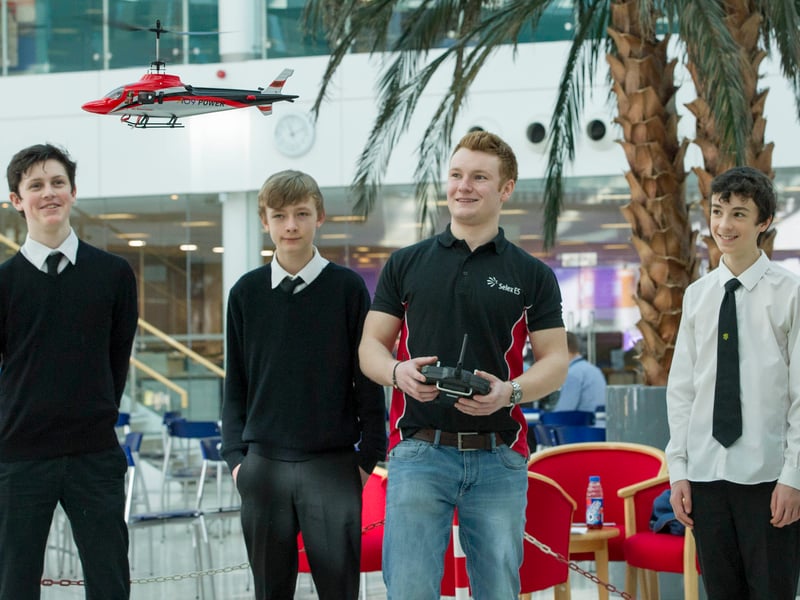 Sandy Lamb, (centre) demonstrates the AW109 helicopter to pupils from Trinity academy, L to R, Owen Hayden-Joiner, William Russell, Sandy Lamb, Sean McLean and Eilidh Spence, as part of Scottish Apprenticeship Week in March, 2016.