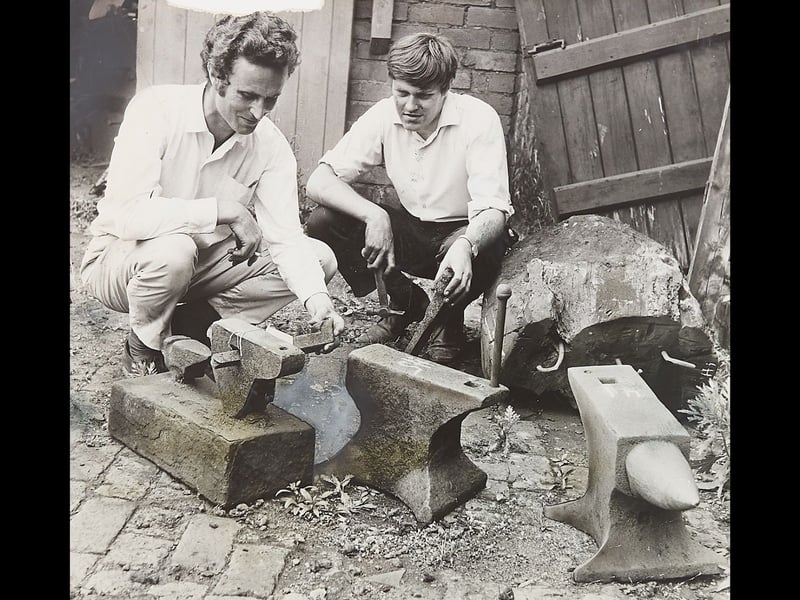 Crouching over heavy iron anvils set on cobbles, Michael Thomas (left), director of the Avoncroft Museum, and Tom Gadd of Manor Lane, Halesowen, inspect industrial artifacts saved from the Cradley chain works on August 3, 1970. As the century-old chainmaking shop was being demolished, key pieces of machinery and tools were carefully salvaged so the historic workshop could be rebuilt and preserved for future generations. The image captures a vital moment in local heritage conservation, ensuring the grit and craftsmanship of the area's iconic chainmaking industry would never be forgotten.   Do you remember the old chainmaking shops around Cradley or visiting Avoncroft Museum to see preserved industrial heritage? Did anyone in your family work in the local chain, nail, or iron manufacturing trades back in the day?