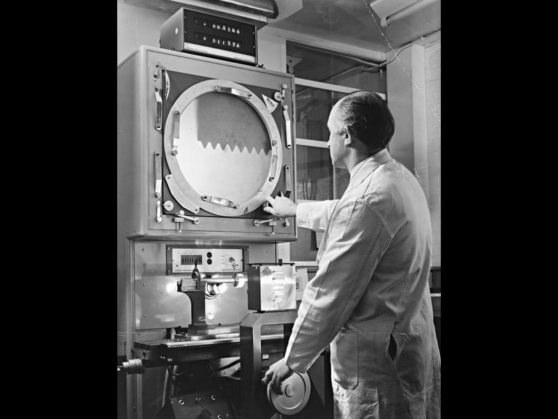 Dressed in his white lab coat, quality assurance foreman Bill McLaughlin inspects a vital Concorde threadform inside the standards room at Dowty Boulton Paul in Wolverhampton on November 23, 1970. Using specialist optical projection equipment that magnified tiny aircraft components many times their actual size, Bill carefully verified the exacting measurements required for Concorde's power control units. The image highlights the immense pride, skill, and cutting-edge aerospace engineering that put local factories at the very forefront of global aviation history during the 1970s. Do you or any of your family remember working at Dowty Boulton Paul during the heyday of aviation engineering? Did you know anyone who helped build parts for Concorde or other iconic aircraft in the local area back then?