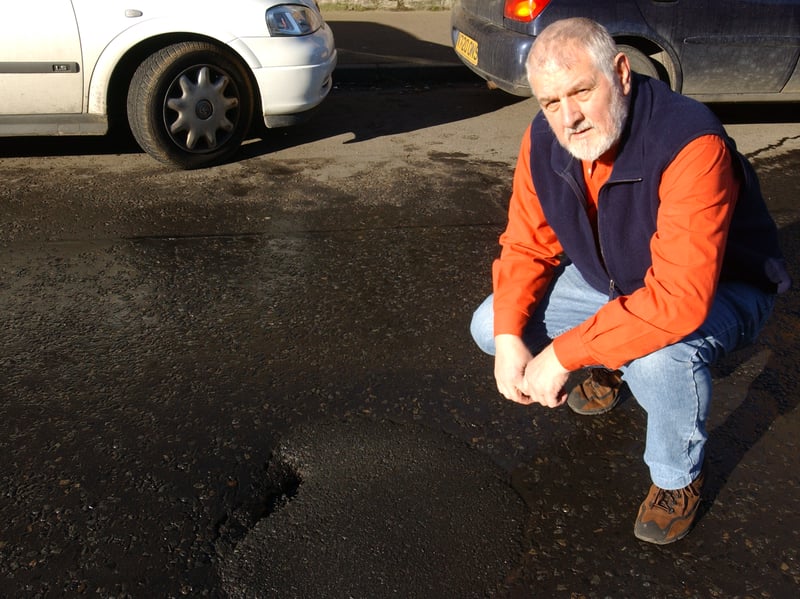 Trinity man George Nicholson, pictured in February, 2004, after being left fed by a burst sewage pipe underneath his road. It was patched up numerous times, yet sewage leaked through leaving the street smelling very bad and occasionally spraying members of the public.